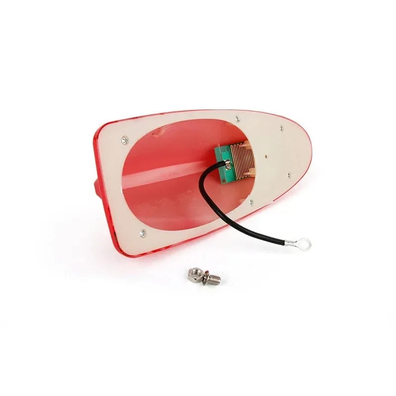 A red decorative car antenna cover with a metal mounting plate and wires.