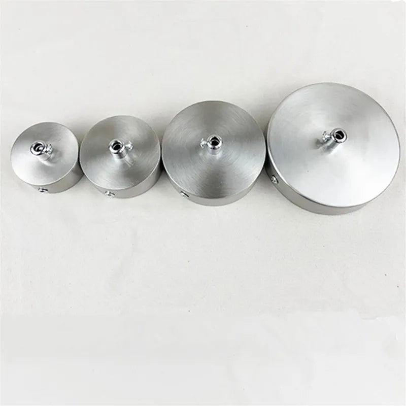 Four modern stainless steel pendant lamp bases arranged in a row.