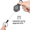 A hand holds a heavy-duty retractable keychain badge holder with a carabiner, showing its extension capability.