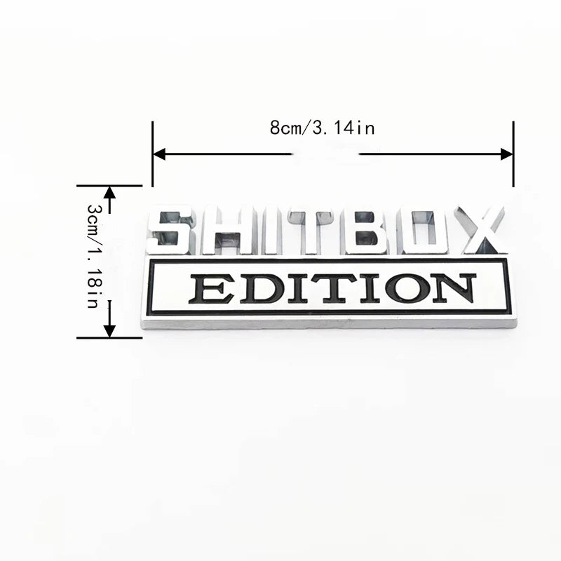 A rectangular black decal featuring the text SHITBOX EDITION, with dimensions 8cm/3.14in by 3cm/1.18in.