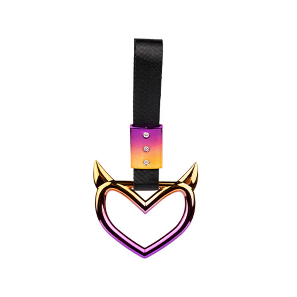 A black strap accessory with a heart-shaped metal charm featuring purple and orange enamel colors.