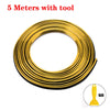A coil of 5 meters of gold-colored universal car molding trim strips with a tool.