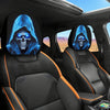 Two car headrest covers featuring glowing blue skulls and menacing faces on black leather seats
