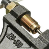 Close-up view of a black universal chain breaker tool with a brass fitting and a threaded rod.