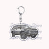 Silver acrylic keychain featuring a detailed model of an off-road truck.