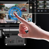 A hand is operating a dash cam device, showing a view of a road and a vehicle with radar detection overlay.