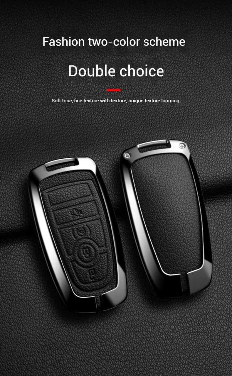 Two black aluminum alloy key fob covers shown against a dark background.
