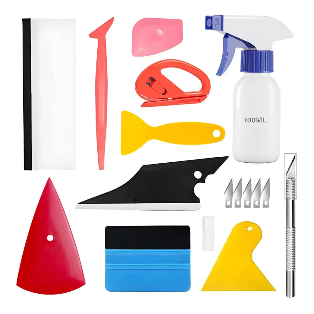 A collection of professional automotive film installation tools including a squeegee, scraper, and various cutting and shapin