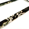 A close-up of a black and white marbled license plate frame decoration.