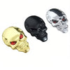 Three chrome skull emblems in gold, black, and silver for motorcycles and cars