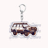Silver acrylic keychain featuring a detailed model of an off-road truck.