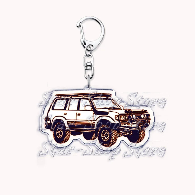 Silver acrylic keychain featuring a detailed model of an off-road truck.