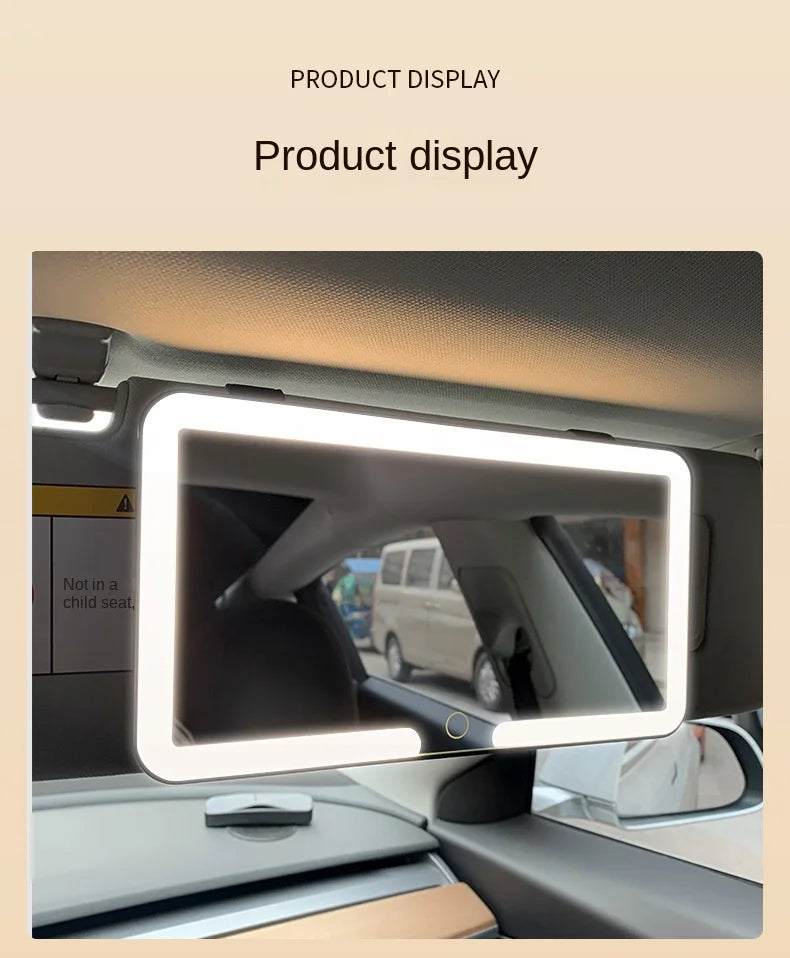 A touch screen vanity mirror is displayed in a car interior, mounted on the dashboard.