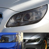 Close-up of a car's headlight assembly showing a tinted film application.