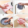 Hands are shown using reusable microfiber cleaning towels to wipe down a sink or faucet.