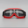 A pair of red and black retro folding motorcycle windproof glasses resting on a gray surface.