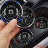 A hand holds a black and blue racing wheel hub design silicone coaster with intricate spokes.
