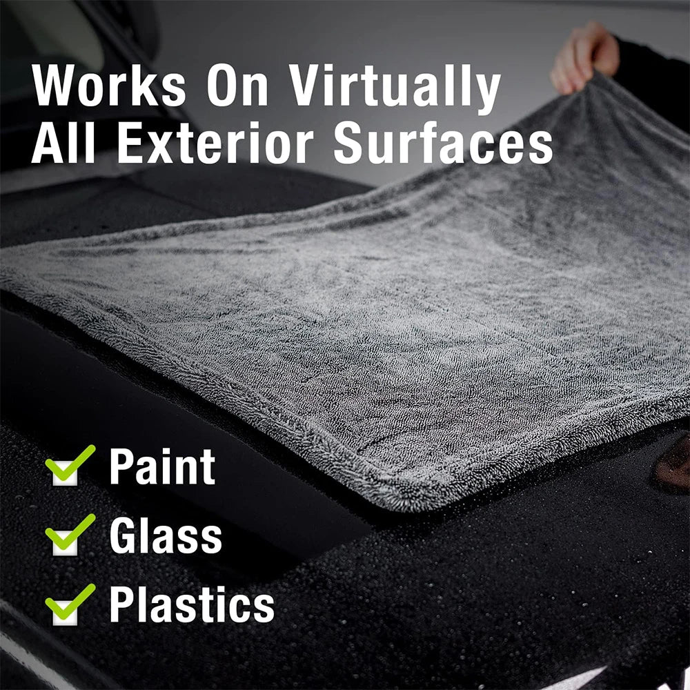 A gray microfiber cleaning cloth is shown working on various exterior surfaces like paint, glass, and plastics.