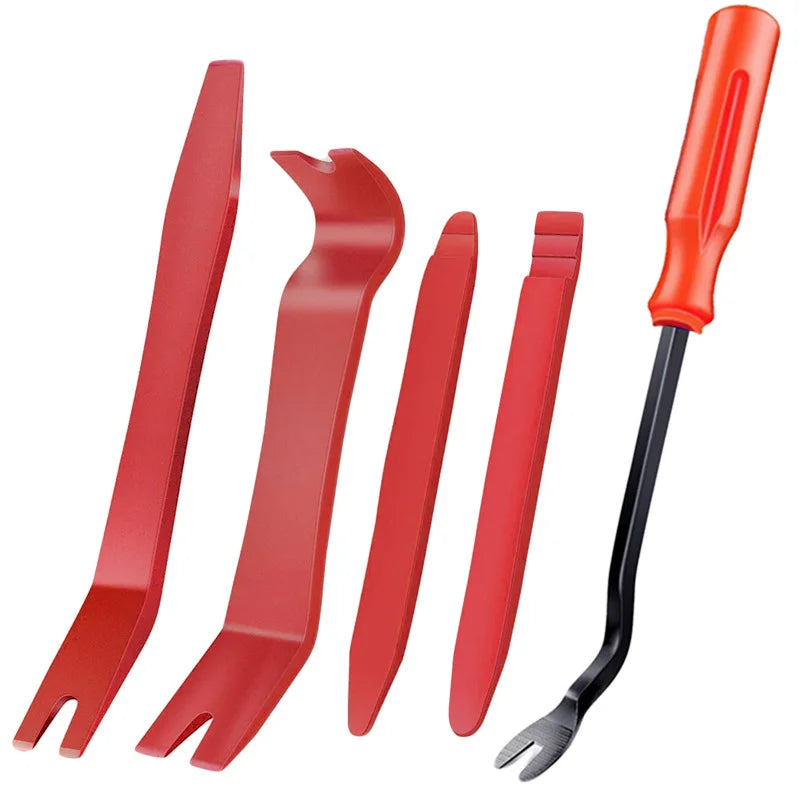 A set of red plastic tools for removing car trim, including various shaped tools and a black pick.
