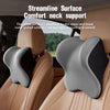 A gray and black ergonomic neck support pillow is shown placed on a tan car seat cushion.