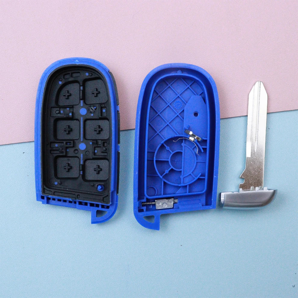 Blue plastic housing for a car key fob with internal components and a metal key blade.