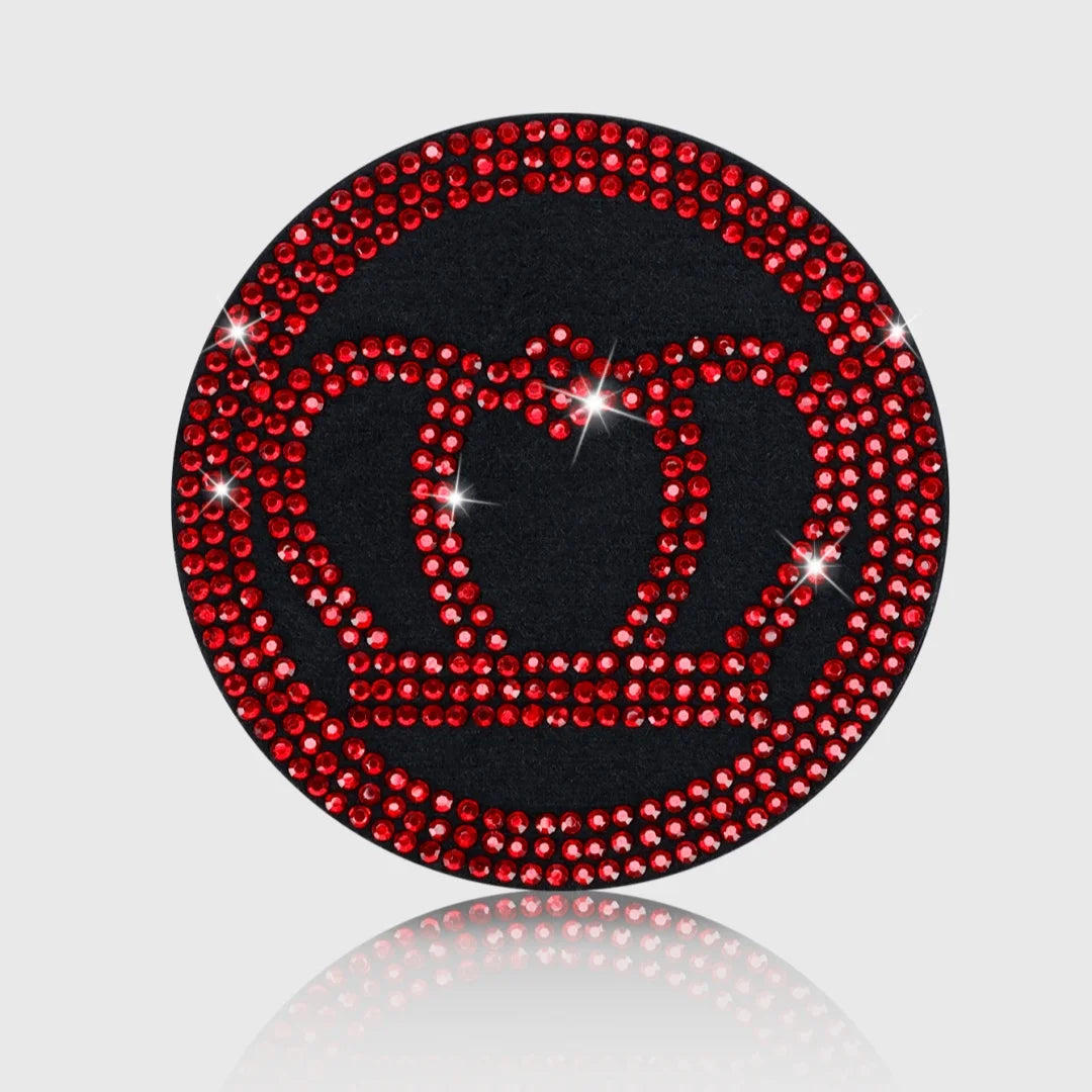 A circular coaster design featuring a red imitation diamond crown set against a black background.