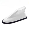 A white, aerodynamic car antenna amplifier with a black base.