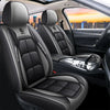 Black leather car seat covers with headrests and side bolsters shown inside a vehicle cabin.