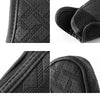 Black artificial leather handbrake cover showing various textures and stitching details.