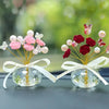 Crystal rose dashboard ornament featuring pink and red faux roses with pearl accents tied with a white ribbon.