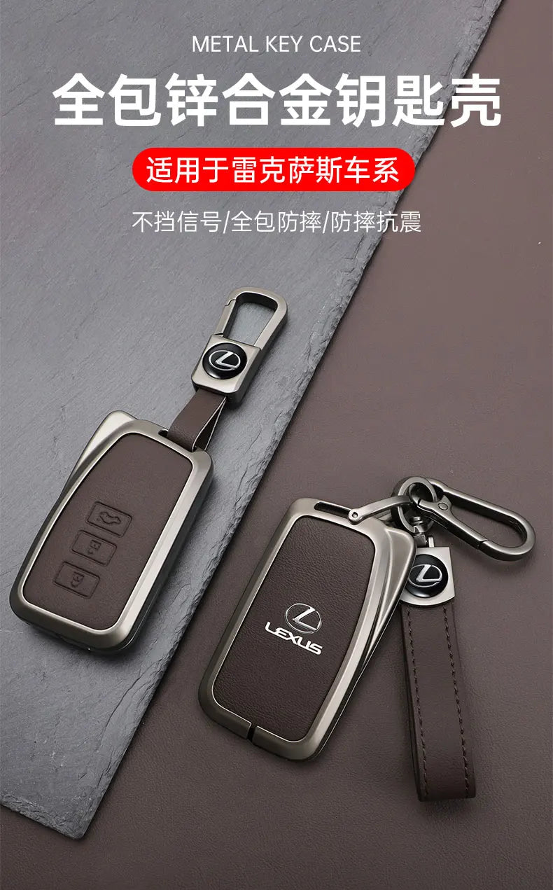 A metal key case for a Lexus car, shown with a leather strap and a key fob.