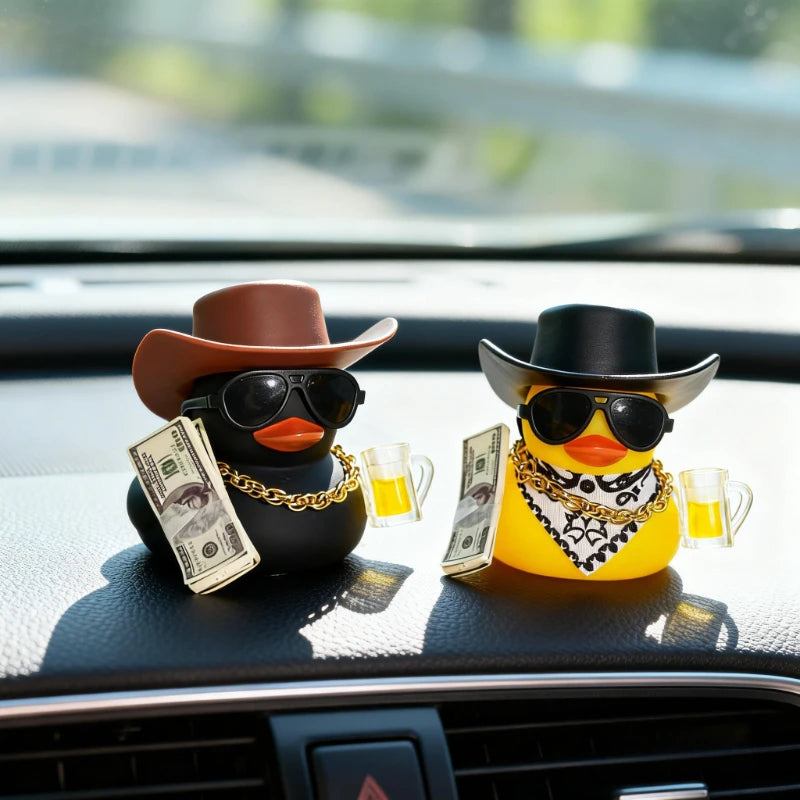 A rubber duck car ornament featuring a duck head and sunglasses sits on a car dashboard with money and a glass.