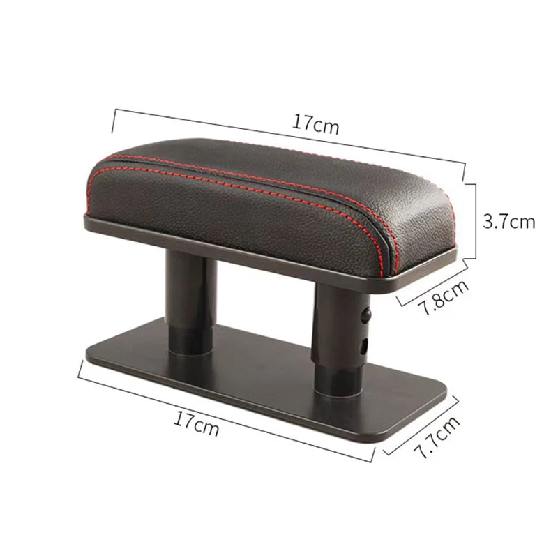 A black ergonomic vehicle armrest cushion with a padded top and a flat base, shown from the side.