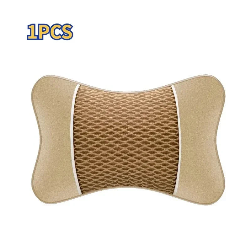 A beige ergonomic leather headrest and neck support cushion with a textured mesh insert.