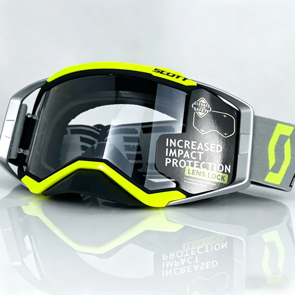 A pair of yellow and black SCOTT impact protection safety goggles resting on a reflective surface.