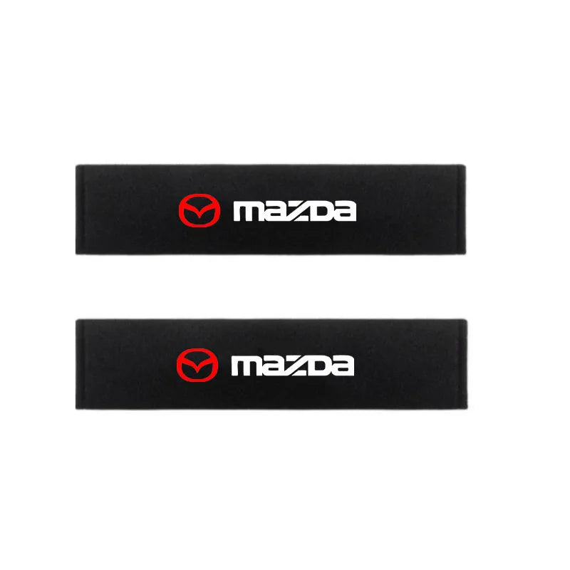 Two black Mazda car headrest seat belt shoulder pads