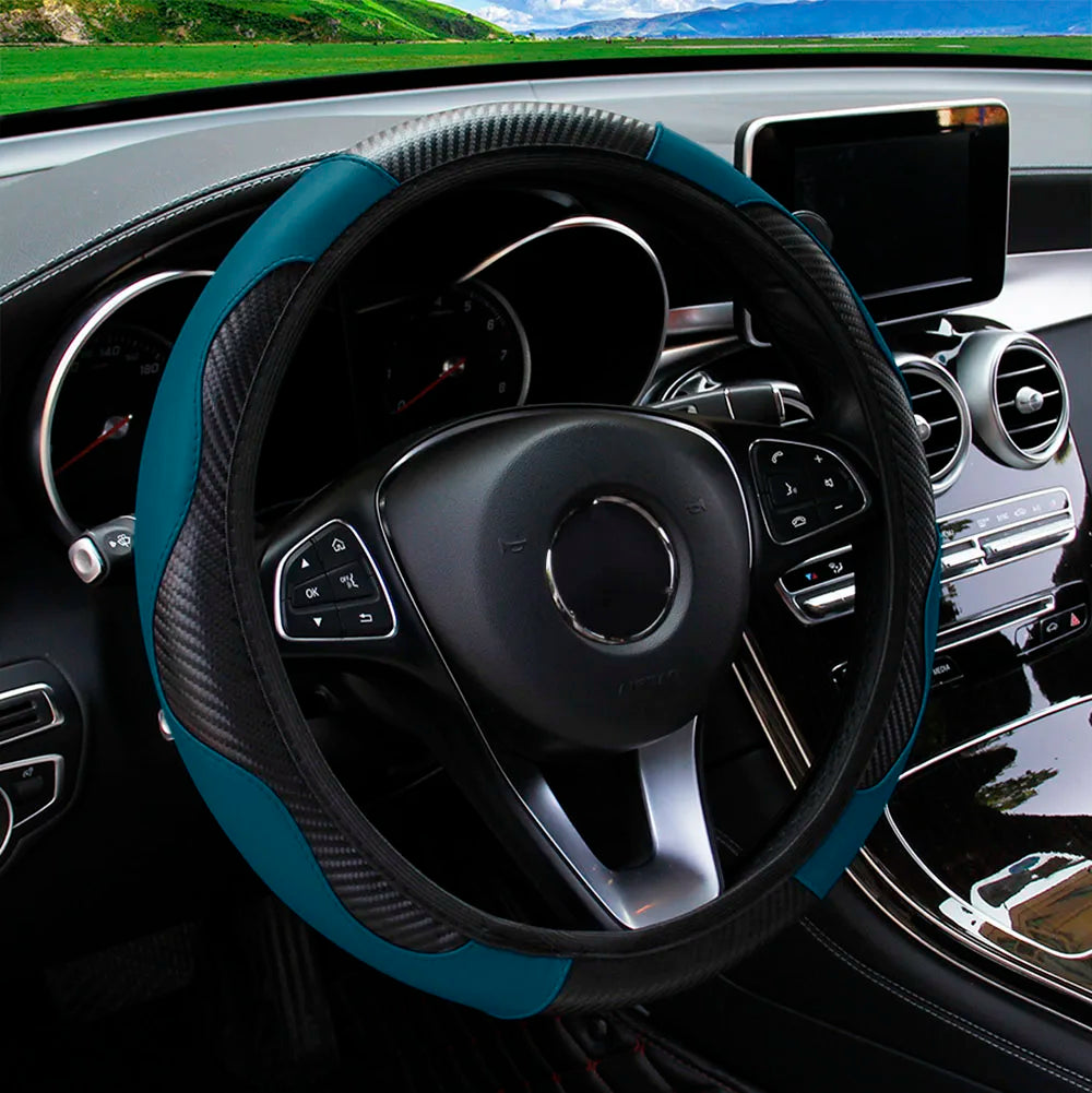 A close-up view of a black steering wheel with a teal PU carbon fiber cover inside a car interior.