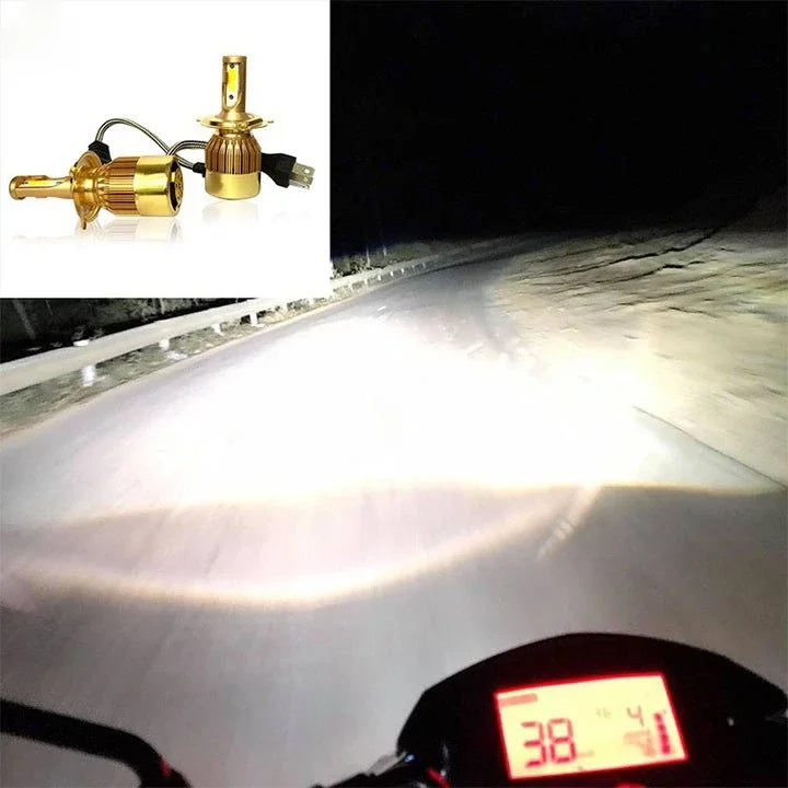 A close-up of dual color car LED headlights illuminating a road at night.