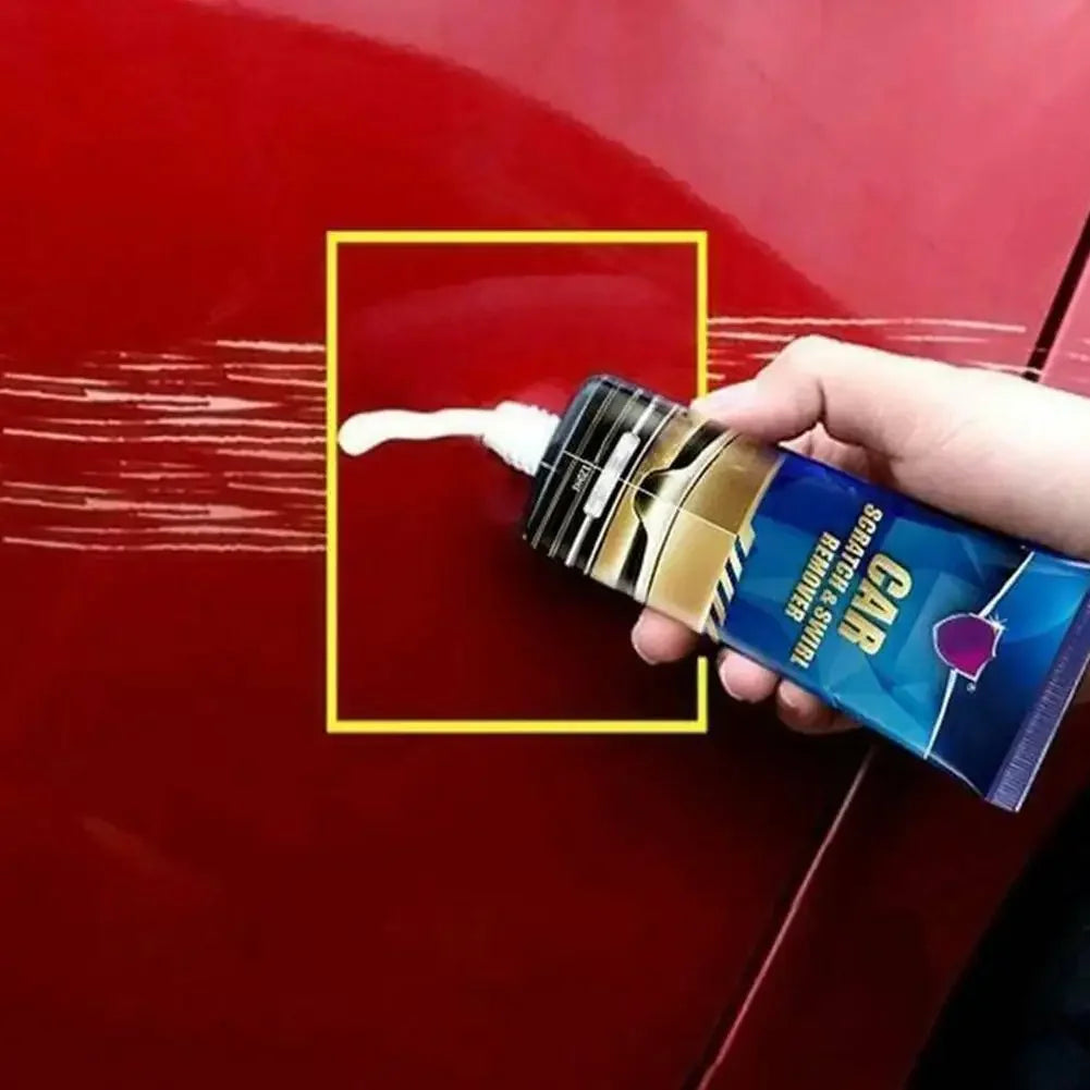 A hand is applying Car Scratch & Swirl Remover polish to a red car surface.