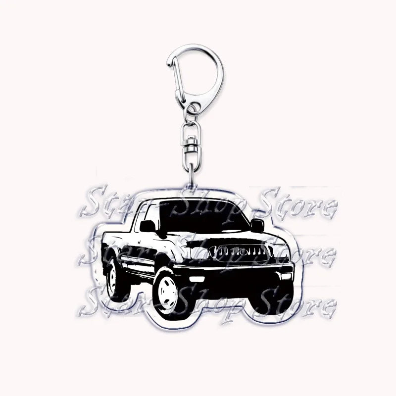 Silver acrylic keychain featuring a black off-road truck model.
