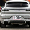 Rear view of a silver Cayenne GTS with a Texas license plate frame displaying KTB0017
