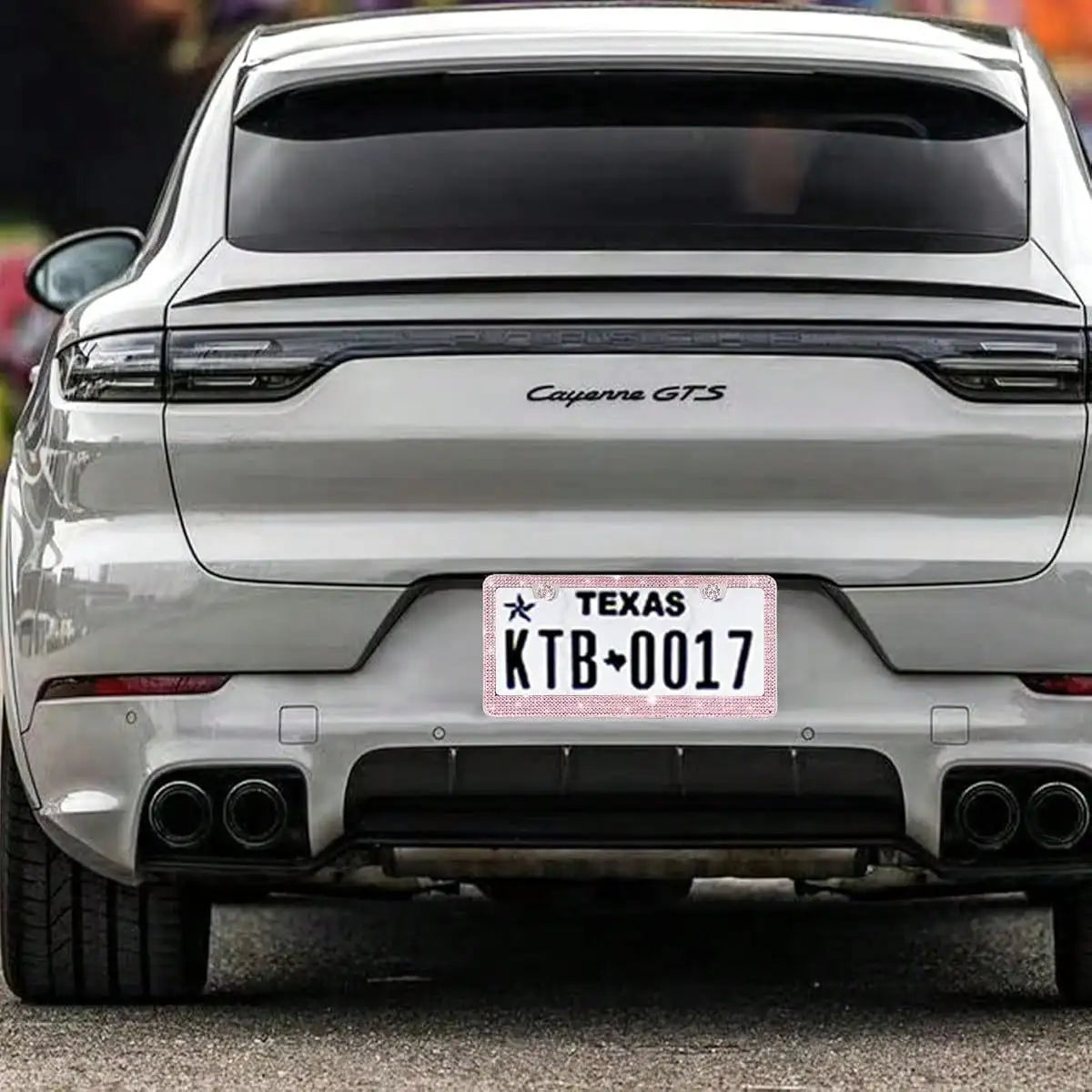 Rear view of a silver Cayenne GTS with a Texas license plate frame displaying KTB0017
