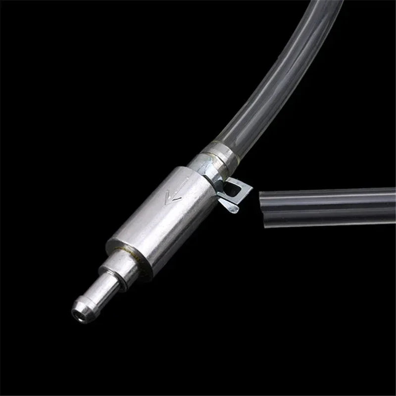 A close-up view of a metal brake fluid bleeder hose kit with a flexible tube attached against a black background.