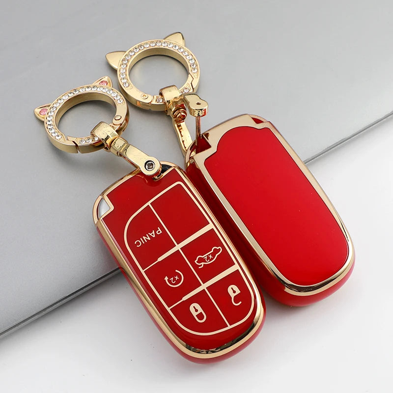 A red plastic car key case with a gold keyring and ring, featuring various key cutouts.