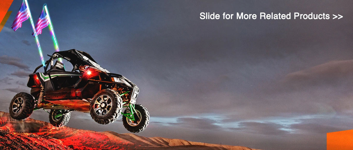 A red and black UTV is shown driving across a dusty landscape with bright lights illuminating the scene.