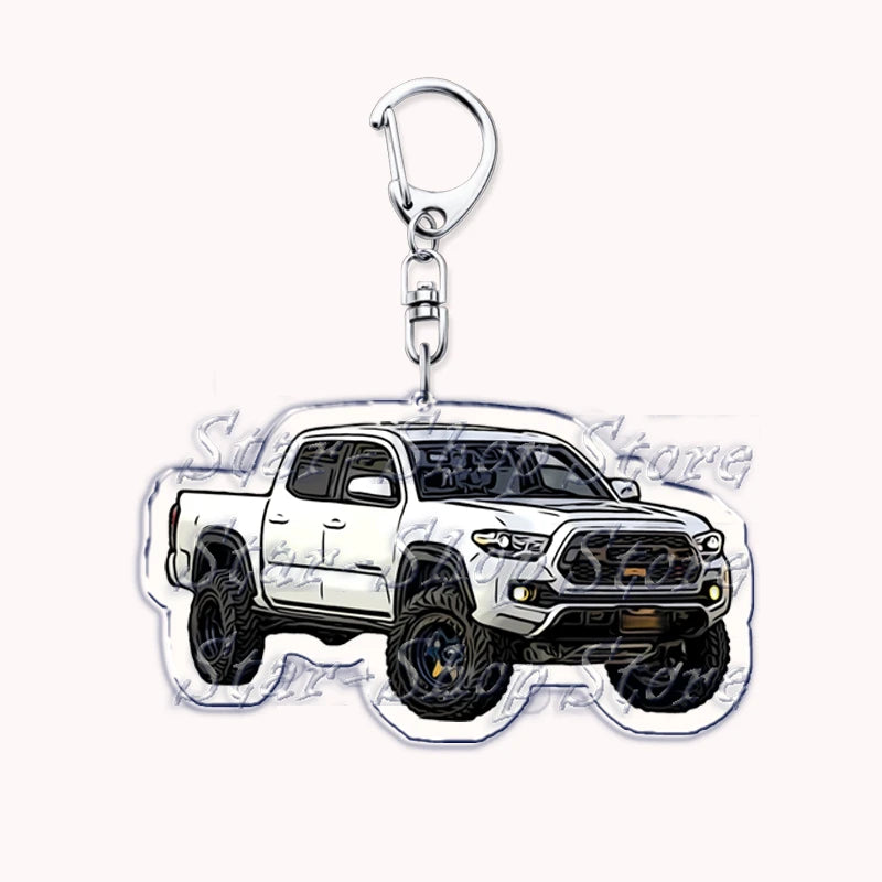 Silver acrylic keychain featuring a white off-road truck model.