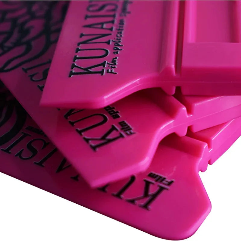 A close-up view of a pink magnetic suction car vinyl wrap film scraper kit.