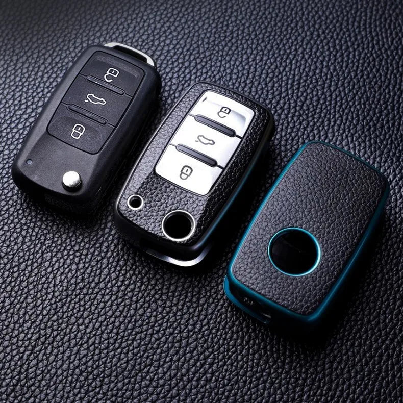 Black TPU leather car key cases for Volkswagen, Skoda, and other vehicles displayed on a dark surface.