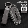 A matte grey buckle key cover for a Nissan Qashqai car key, shown with applicable keys.