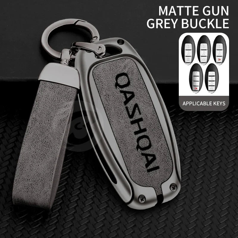 A matte grey buckle key cover for a Nissan Qashqai car key, shown with applicable keys.